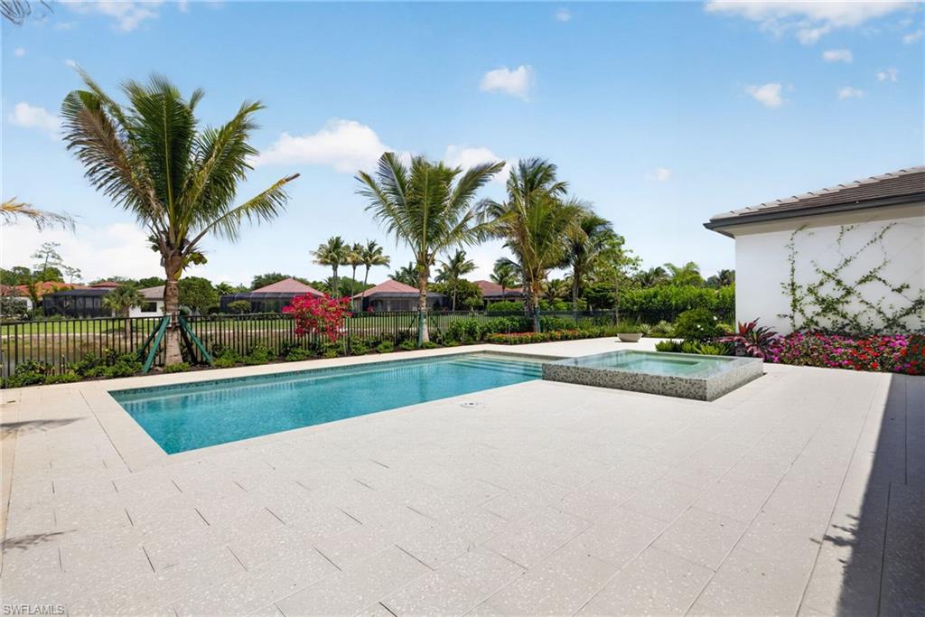 16736 Lucarno Way Naples, FL 34110 - Photo 32 of 49 Tropical trees and plantings surround the outdoor living space