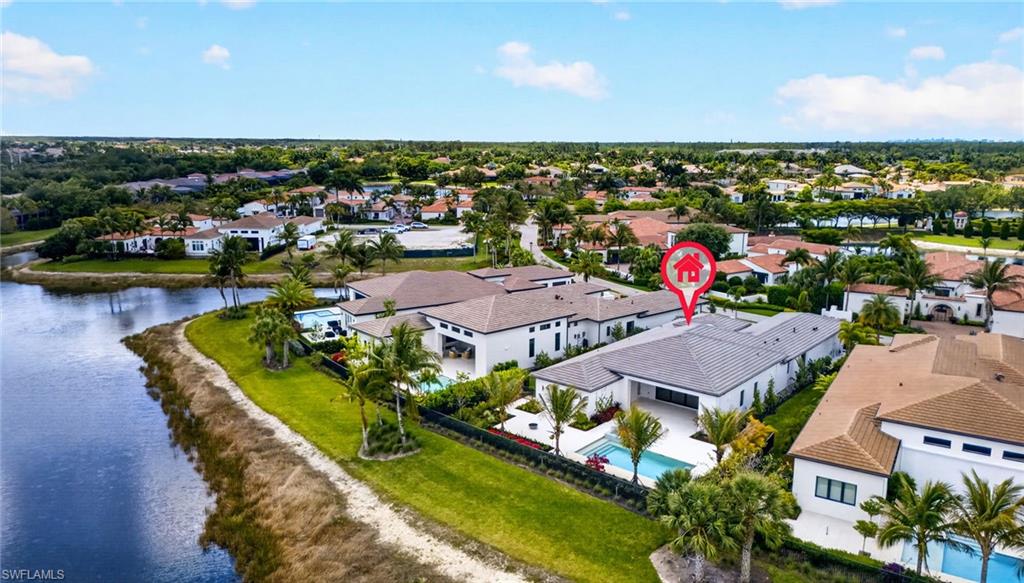 16736 Lucarno Way Naples, FL 34110 - Photo 37 of 49 Aerial view of residential area with a pool and a large body of water