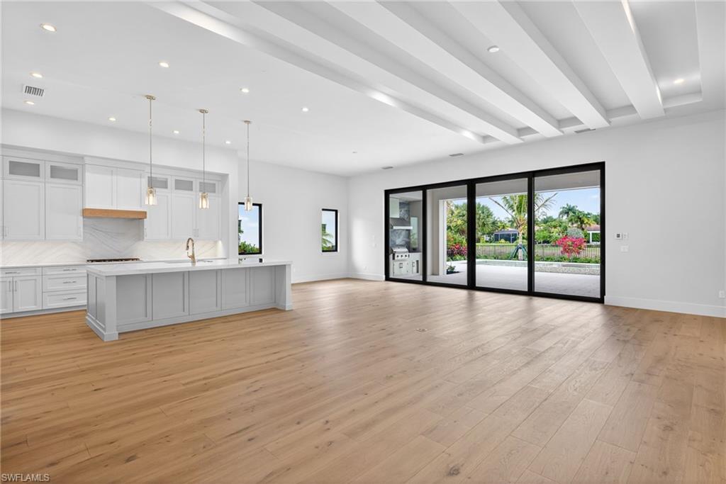 16736 Lucarno Way Naples, FL 34110 - Photo 7 of 49 OPen concept living room, dining room and kitchen space.