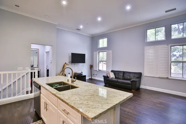 a kitchen with sink stove and refrigerator