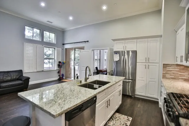 a kitchen with refrigerator cabinets and wooden floor