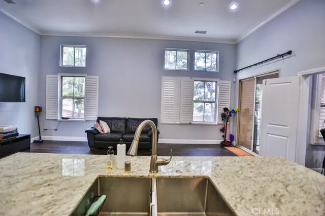 a living room with furniture windows and a flat screen tv