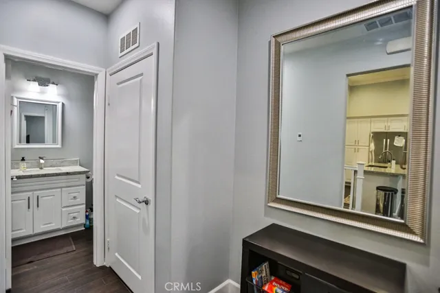 a bathroom with a granite countertop sink a mirror and a window