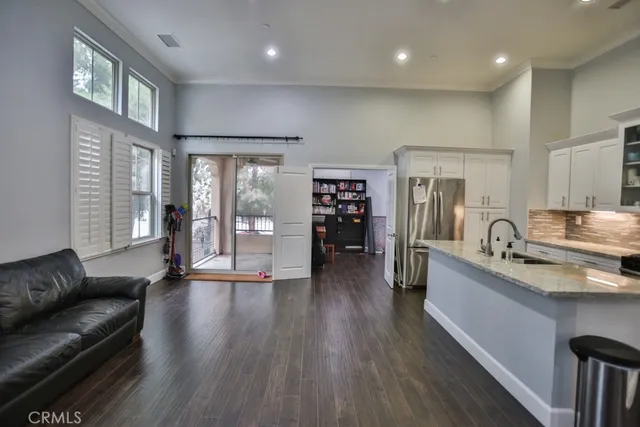 a view of a kitchen with a sink stainless steel appliances and cabinets