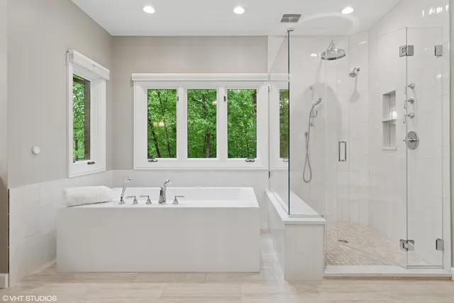 a bathroom with a bathtub and a shower