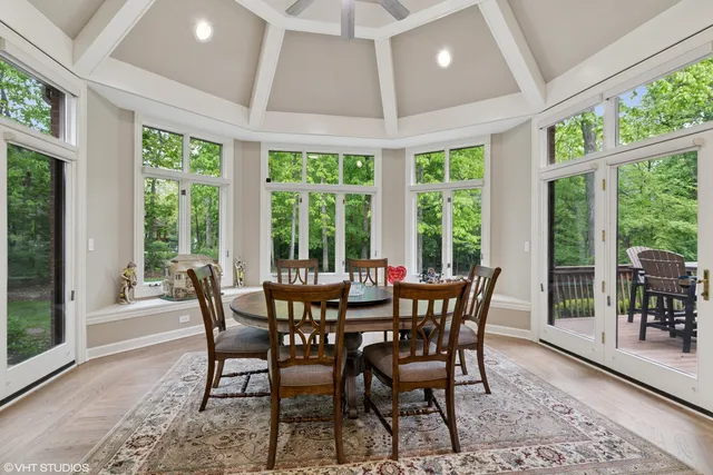 a view of a dining room with furniture large windows and wooden floor