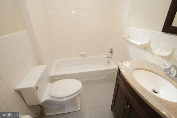 a bathroom with a sink a toilet and bathtub