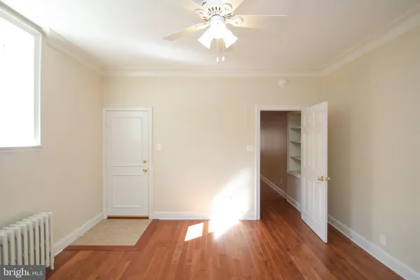 a view of an empty room and wooden floor