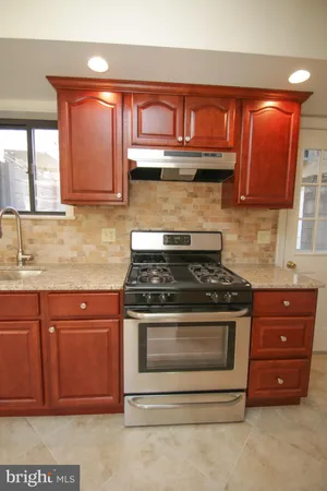 a kitchen with stainless steel appliances granite countertop a stove and a sink