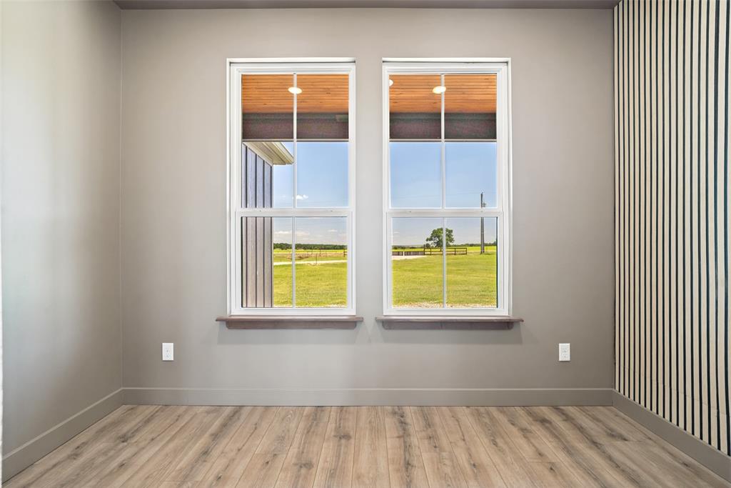 1150 Doss Road Millsap, TX 76066 - Photo 19 of 32 Interior office space featuring two large windows with white frames and wood-finish sills. A great space to get some work done while still enjoying the scenery and natural lighting.