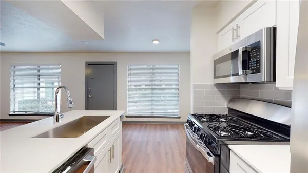 a kitchen with granite countertop a stove and a sink