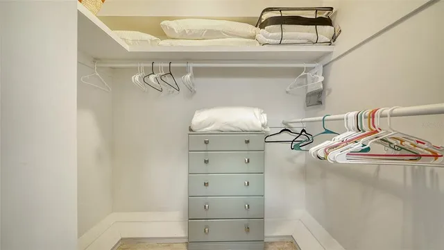 a bedroom with a bed and a mirror