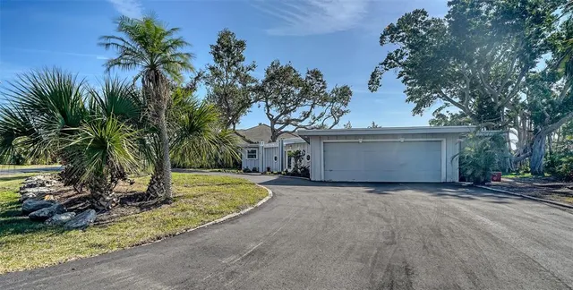 a view of a house with a yard and tree
