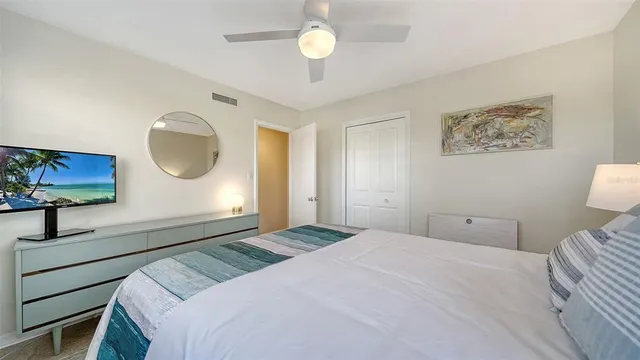 a view of house with a big yard potted plants and large tree