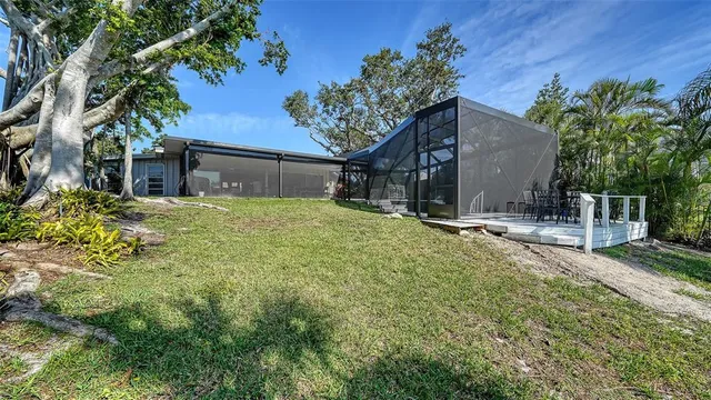 a front view of a house with a yard and potted plants