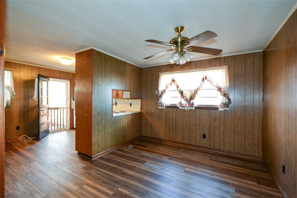 6267 Mt Pisgah Road Ellijay, GA 30540 - Photo 12 of 55 a view of a livingroom with wooden floor and a ceiling fan