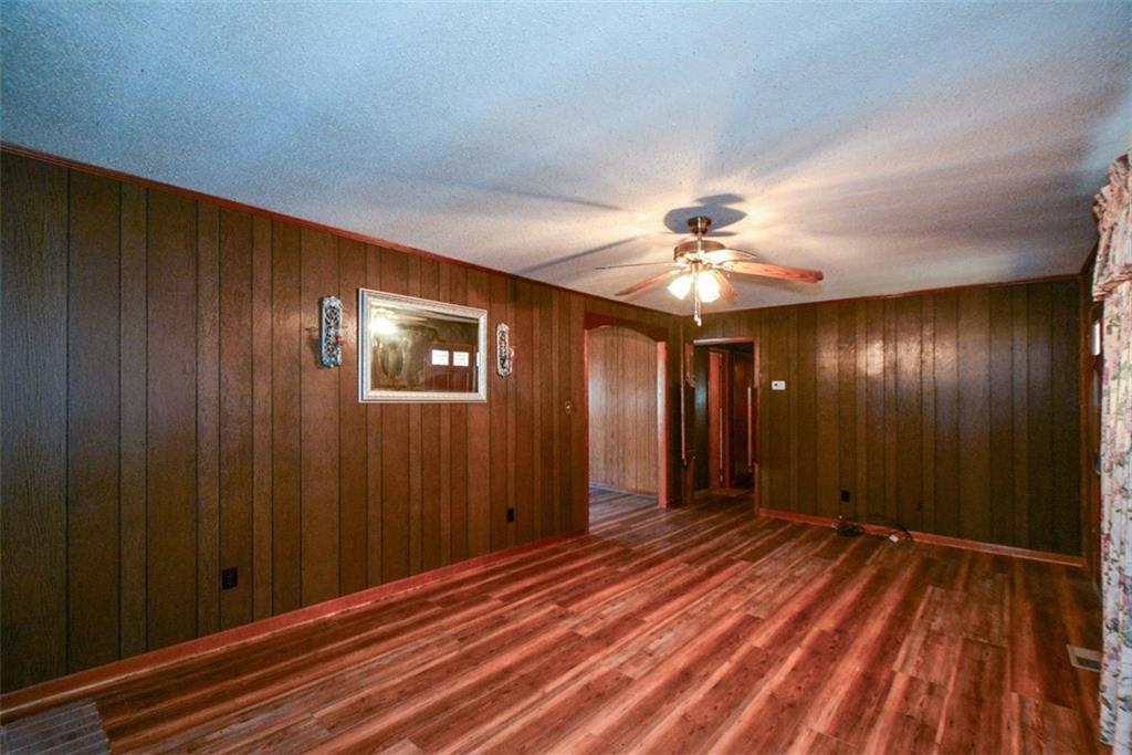 6267 Mt Pisgah Road Ellijay, GA 30540 - Photo 10 of 55 wooden floor in an empty room with a chandelier fan