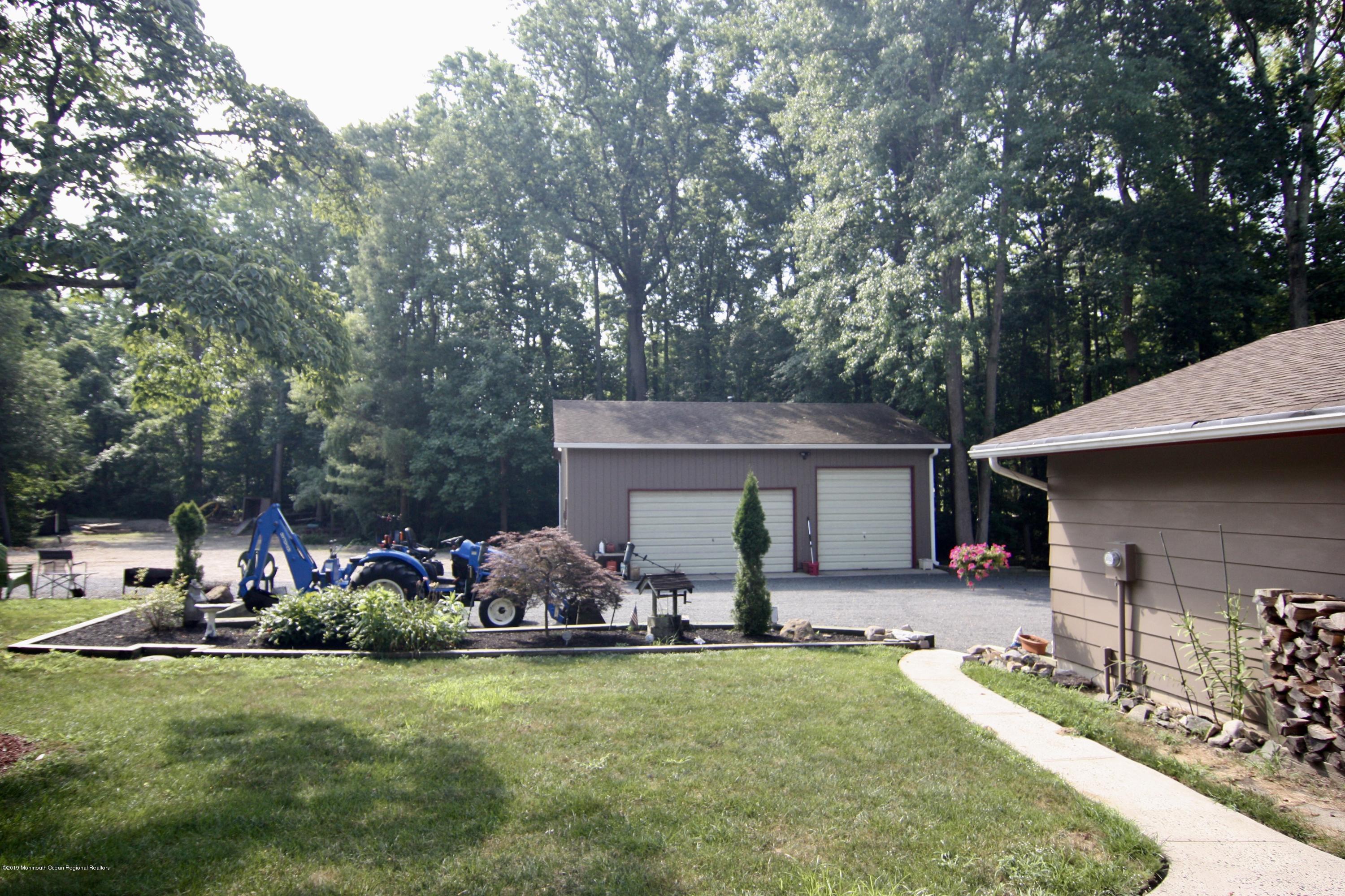 184 Old Tavern Road Farmingdale, NJ 07727 - Photo 8 of 39 a front view of a house with garden and trees