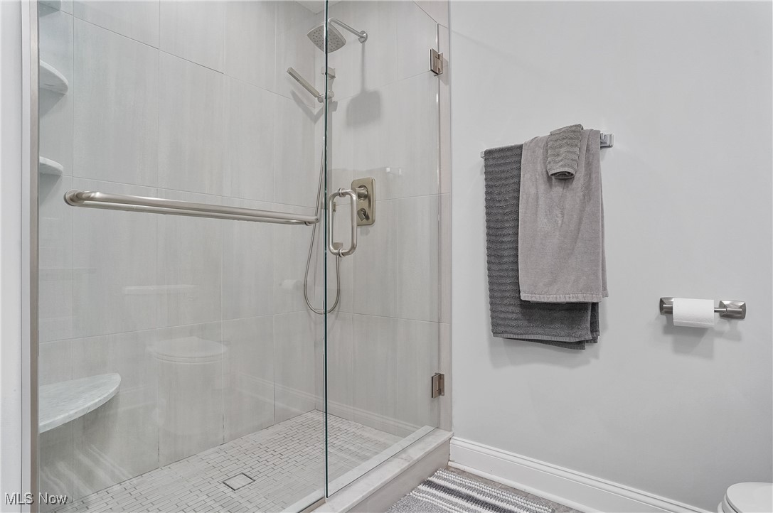 603 South Raccoon Road, Unit 13 Youngstown, OH 44515 - Photo 19 of 27 Full bathroom featuring a shower stall, toilet, and baseboards