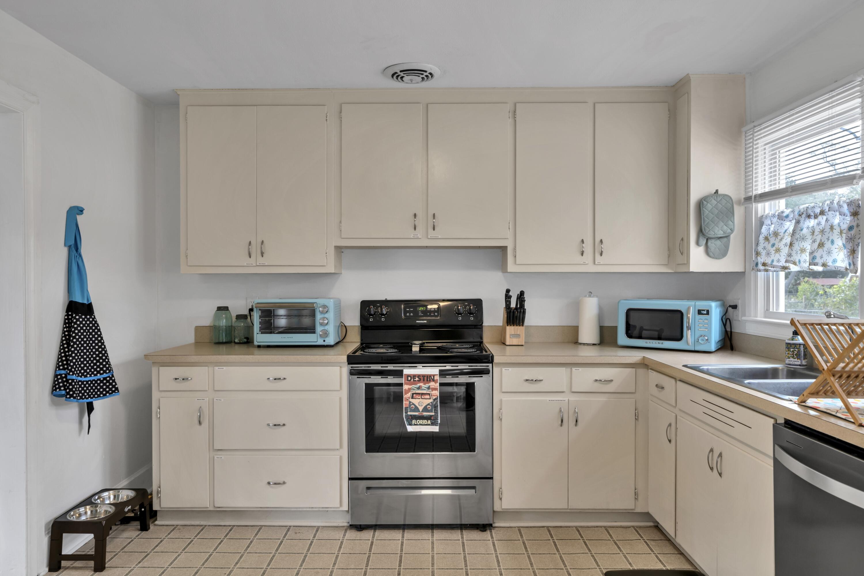 13382 Highway 20 Freeport, FL 32439 - Photo 18 of 43 a kitchen with white cabinets and appliances