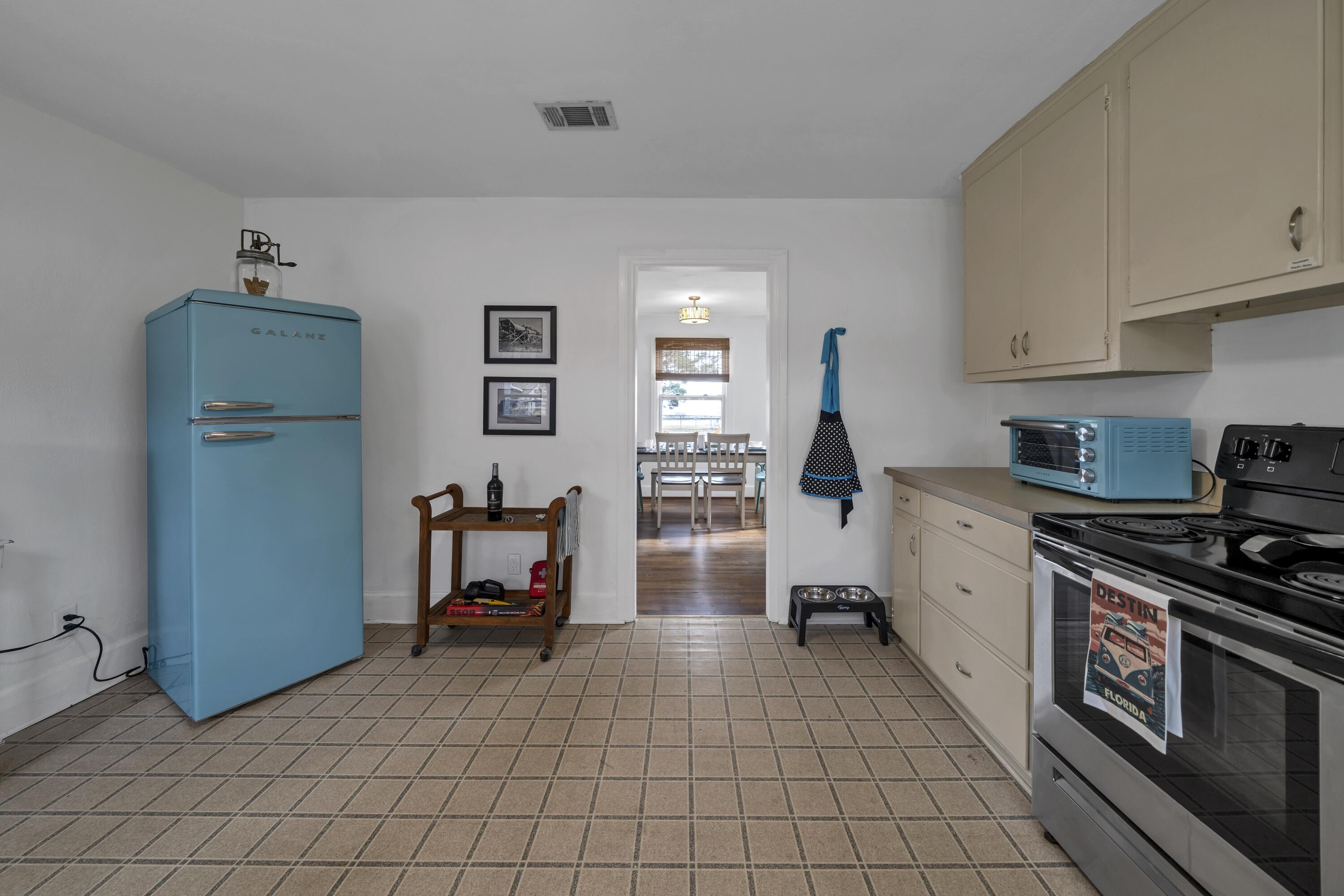 13382 Highway 20 Freeport, FL 32439 - Photo 20 of 43 a kitchen with white cabinets a stove and a refrigerator