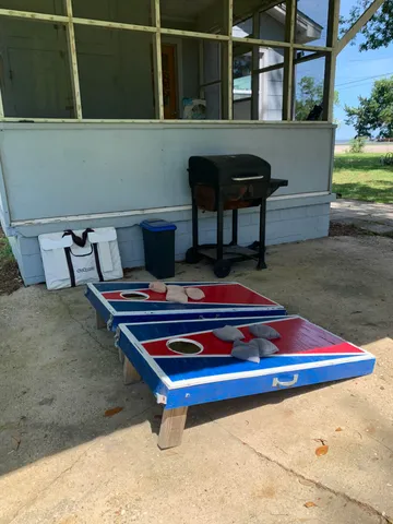 a view of a house with backyard and porch