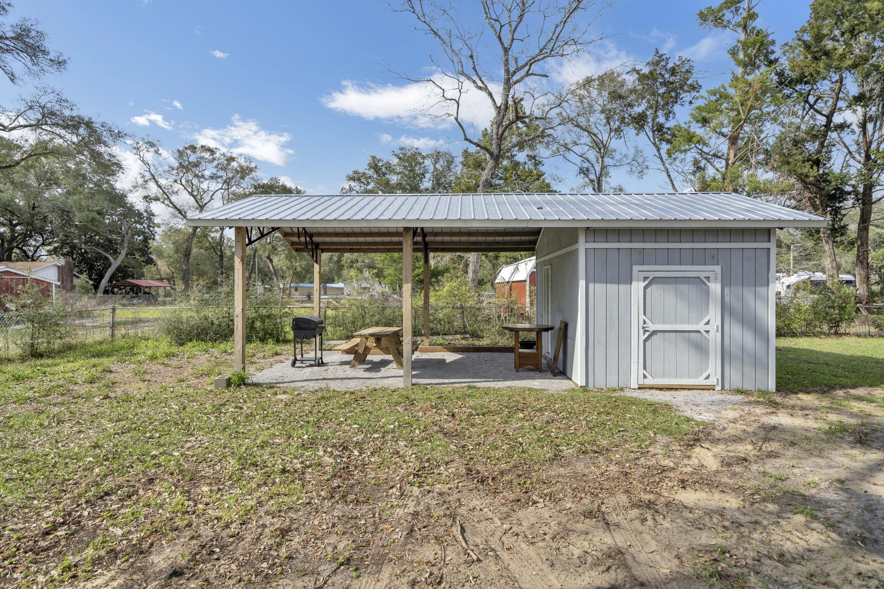 13382 Highway 20 Freeport, FL 32439 - Photo 40 of 43 a view of a house with backyard and porch