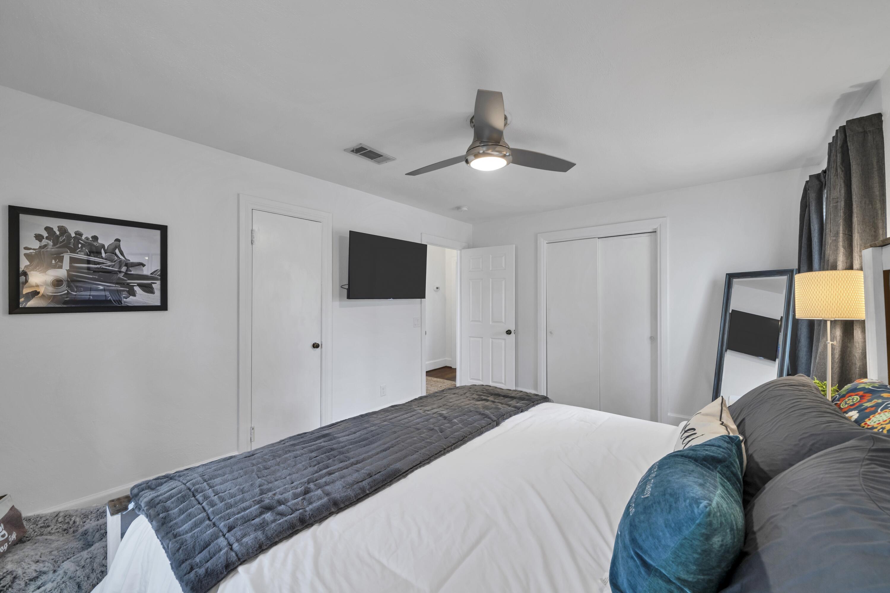 13382 Highway 20 Freeport, FL 32439 - Photo 7 of 43 a bedroom with a large bed and a flat tv screen on dresser