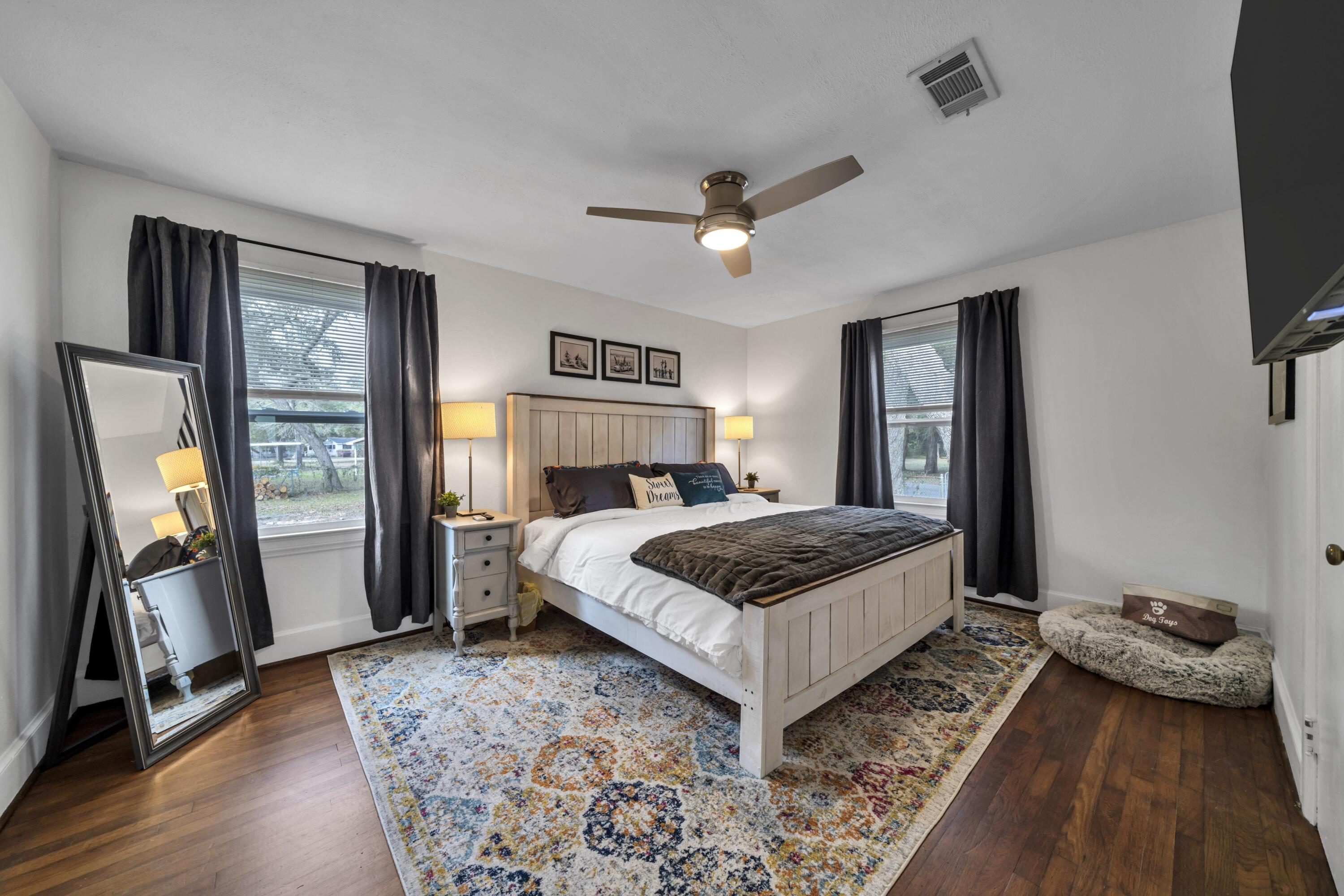 13382 Highway 20 Freeport, FL 32439 - Photo 8 of 43 a bedroom with a bed and a flat tv screen on dresser