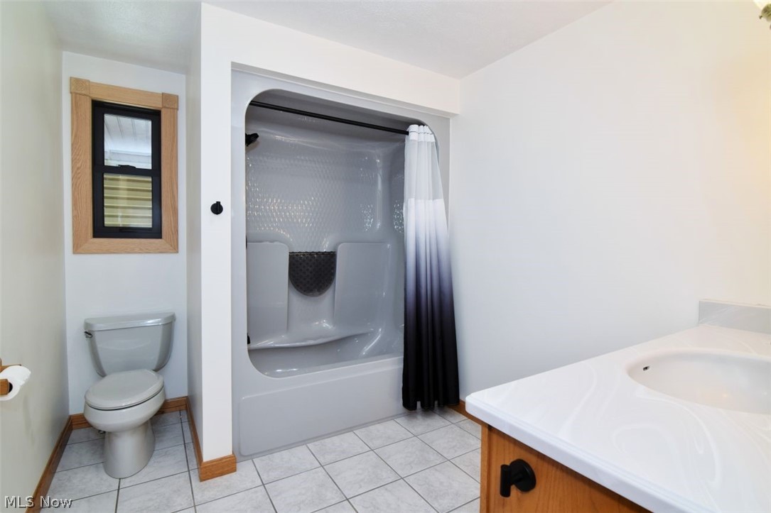 15227 Leroy Road Thompson, OH 44086 - Photo 23 of 50 Full bath with tub/shower combo, Andersen window, large vanity, ceramic flooring.