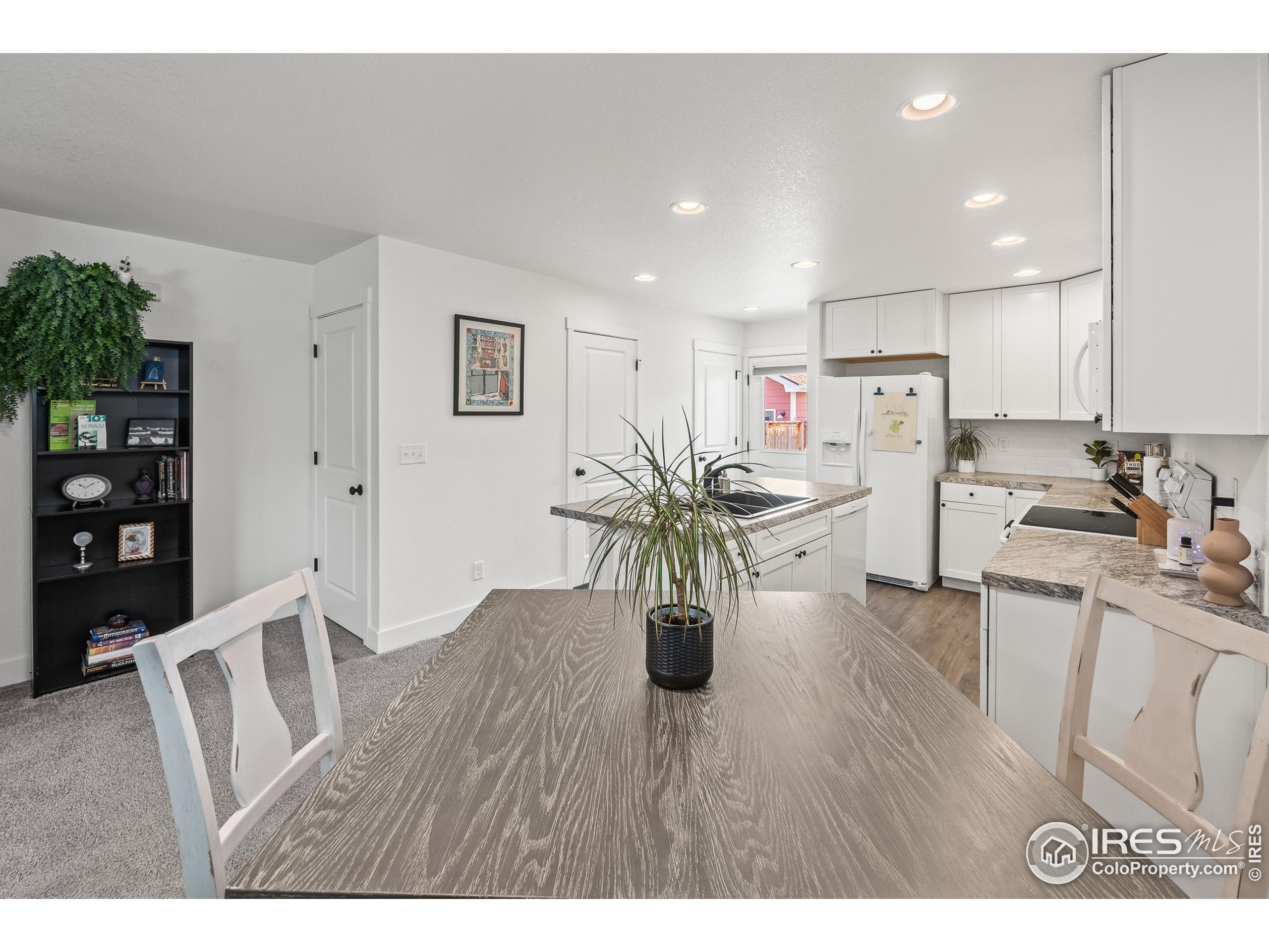 2771 Red Wheat Trail Berthoud, CO 80513 - Photo 17 of 46 a view of kitchen with cabinets and wooden floor