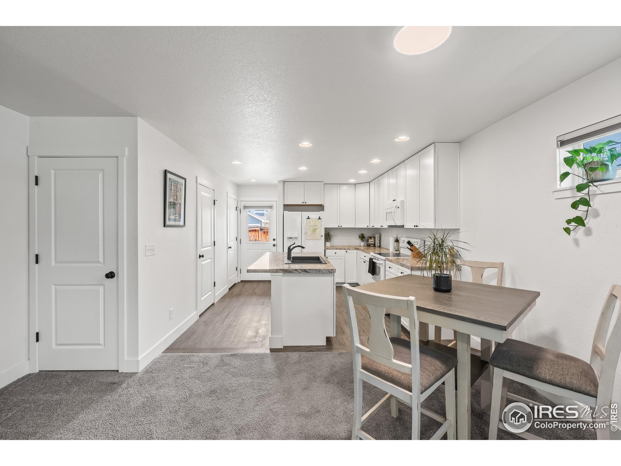 2771 Red Wheat Trail Berthoud, CO 80513 - Photo 18 of 46 a kitchen with a table and chairs
