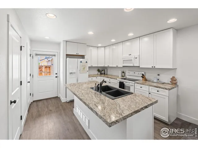 a view of a workspace with furniture and a potted plant