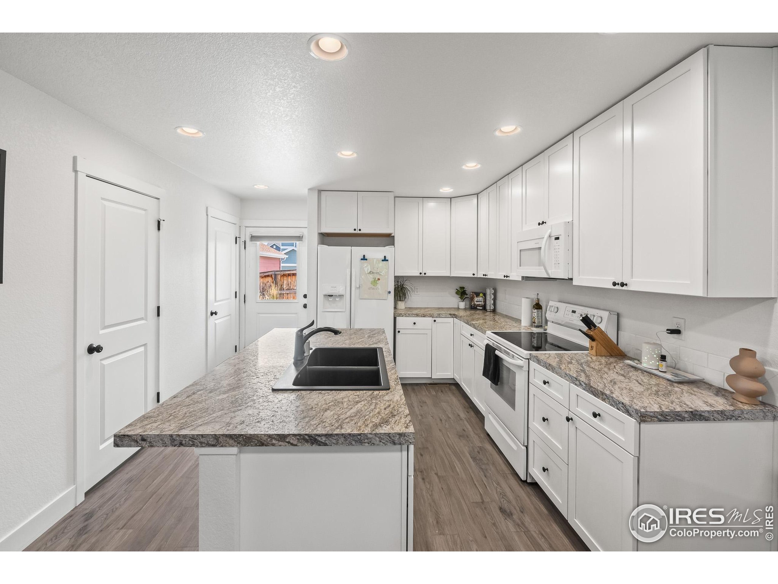 2771 Red Wheat Trail Berthoud, CO 80513 - Photo 20 of 46 a kitchen with cabinets and window