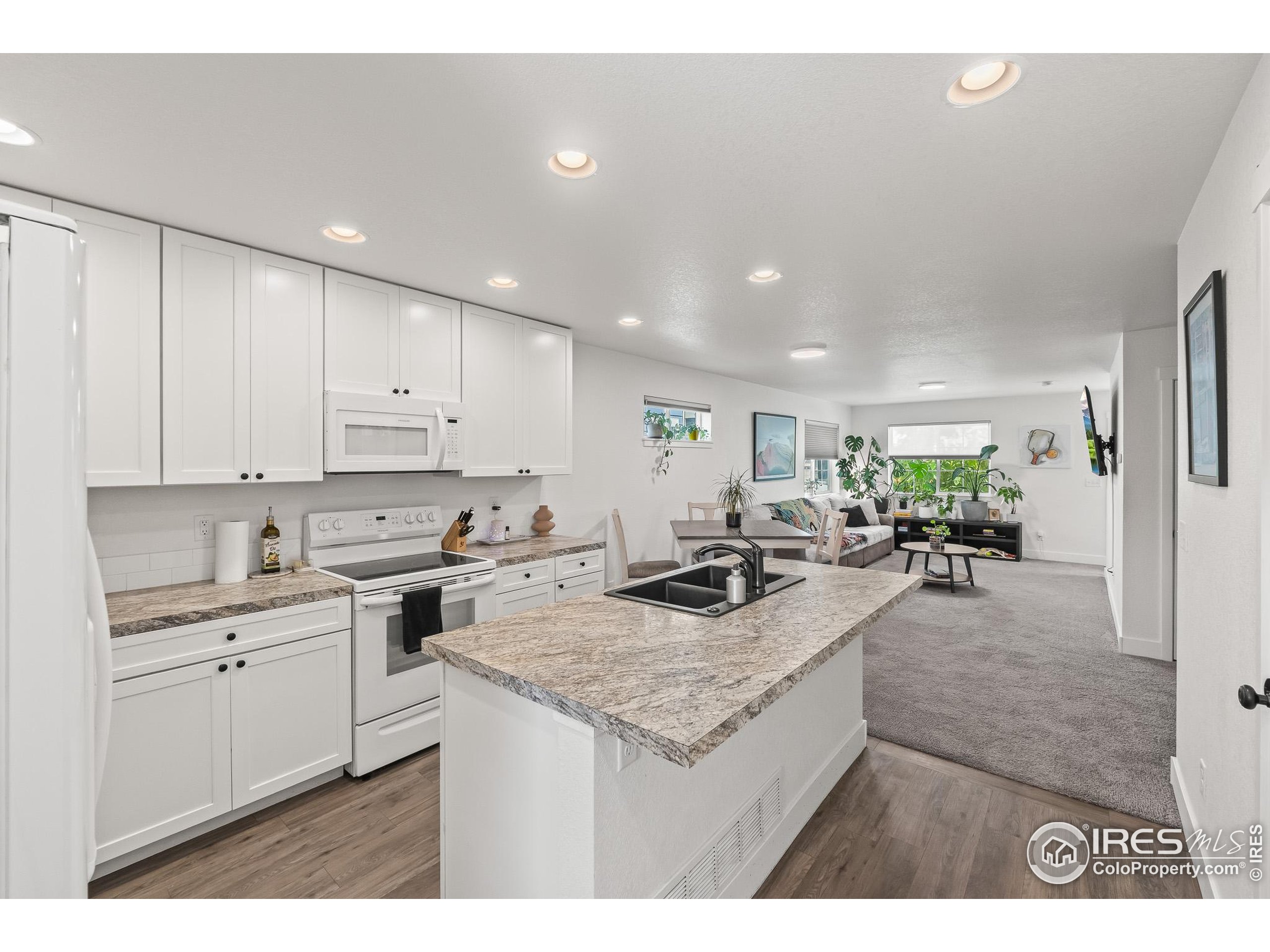 2771 Red Wheat Trail Berthoud, CO 80513 - Photo 21 of 46 a kitchen with sink stove and cabinets