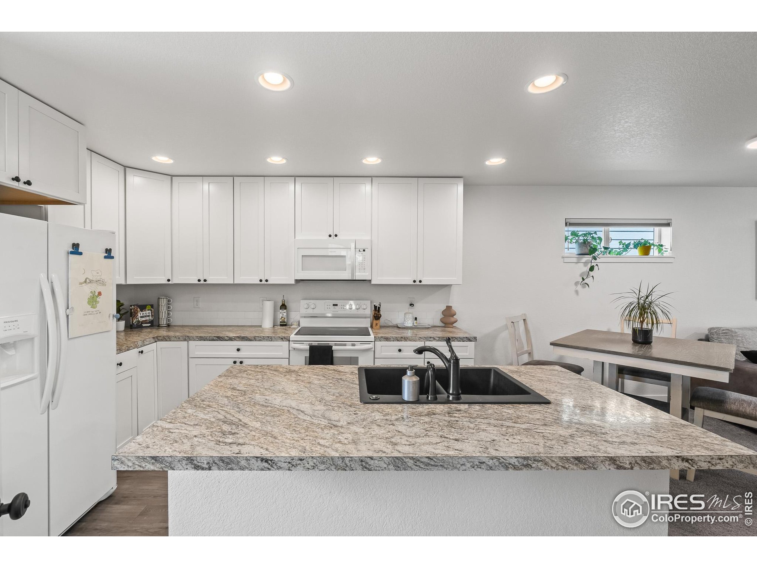 2771 Red Wheat Trail Berthoud, CO 80513 - Photo 22 of 46 a kitchen with stainless steel appliances granite countertop a sink refrigerator and cabinets