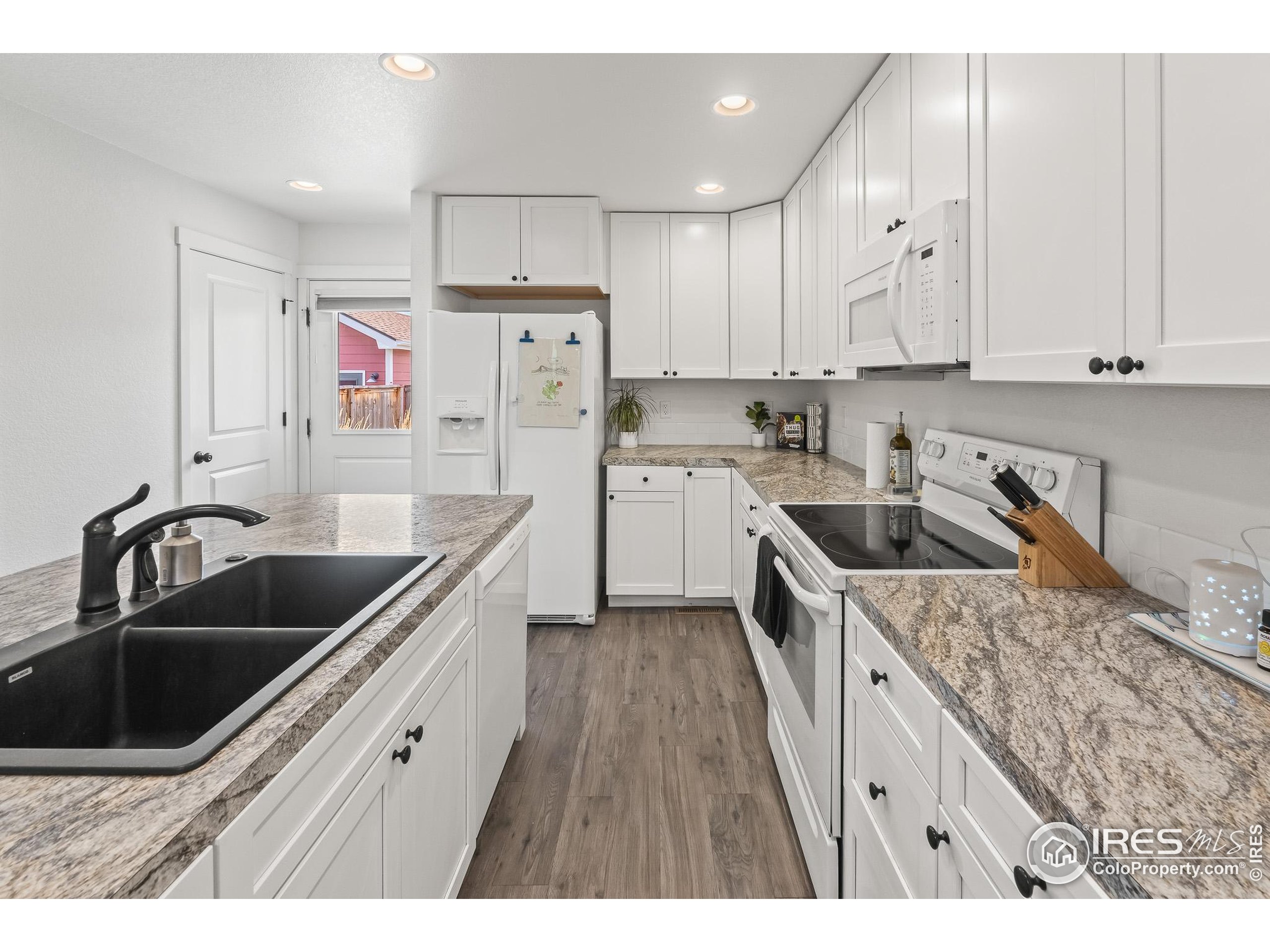 2771 Red Wheat Trail Berthoud, CO 80513 - Photo 23 of 46 a kitchen that has a sink cabinets counter space and stainless steel appliances