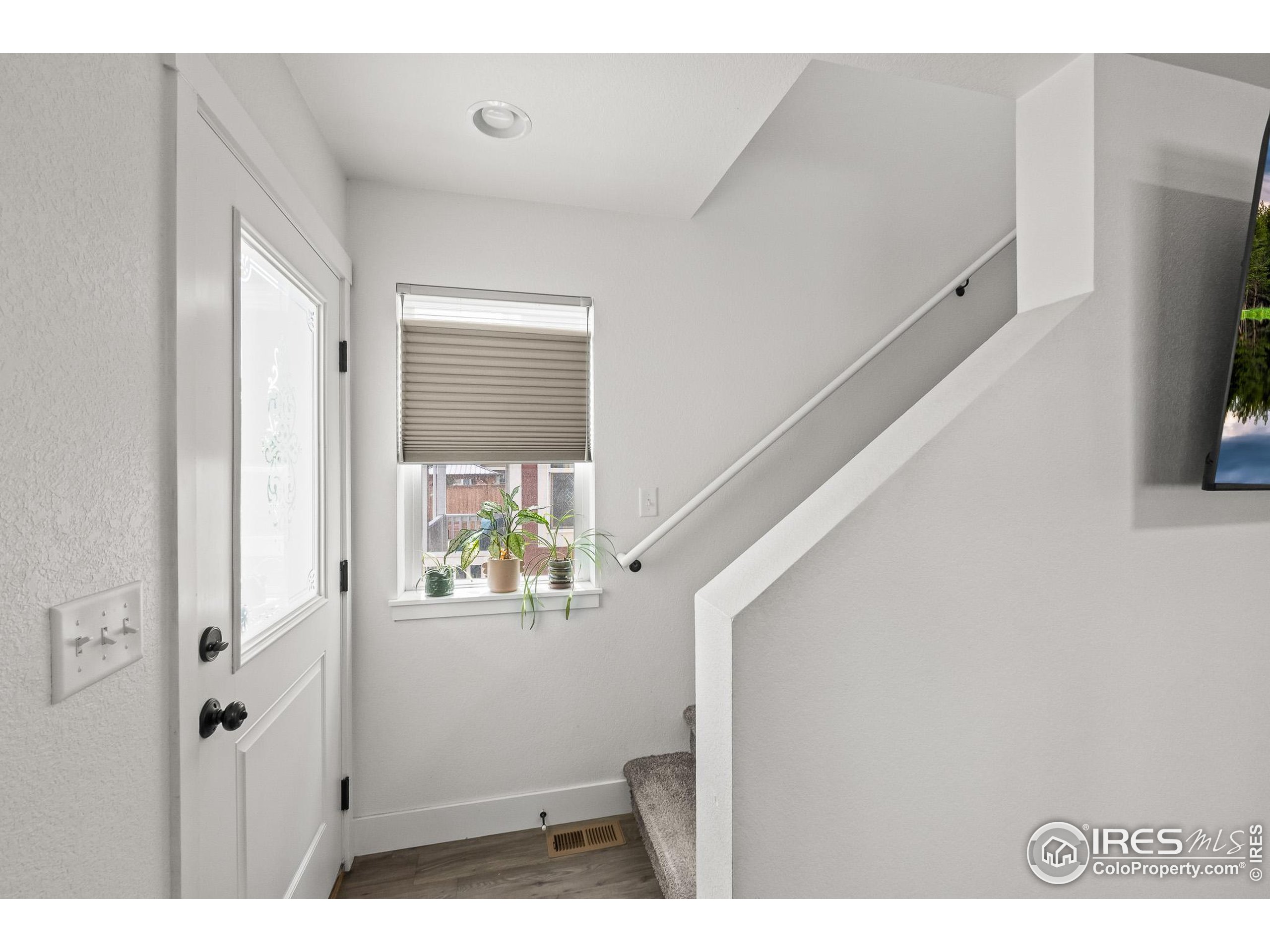 2771 Red Wheat Trail Berthoud, CO 80513 - Photo 26 of 46 a view of an entryway with wooden floor