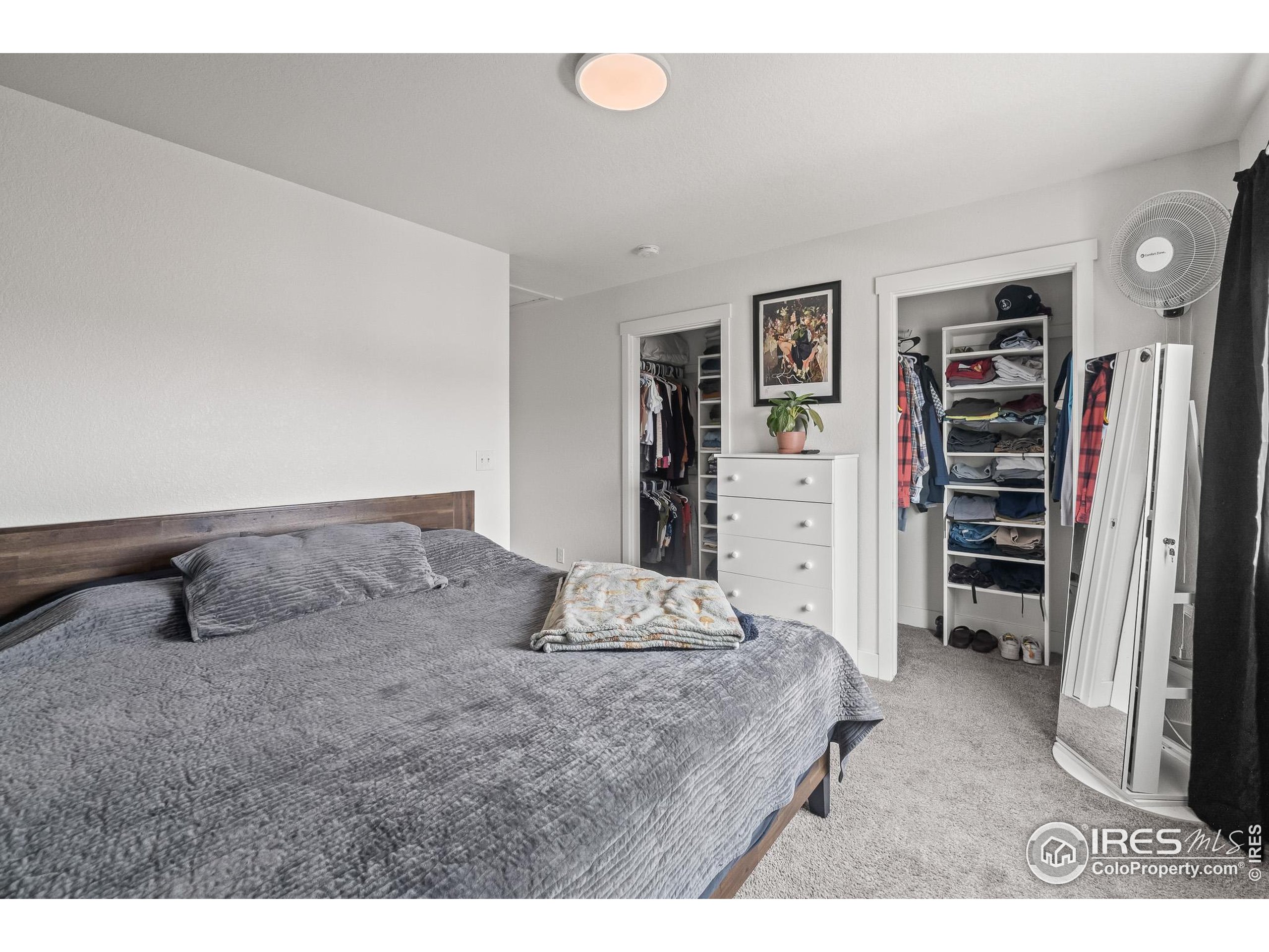 2771 Red Wheat Trail Berthoud, CO 80513 - Photo 28 of 46 a bedroom with a large bed and a walk in closet