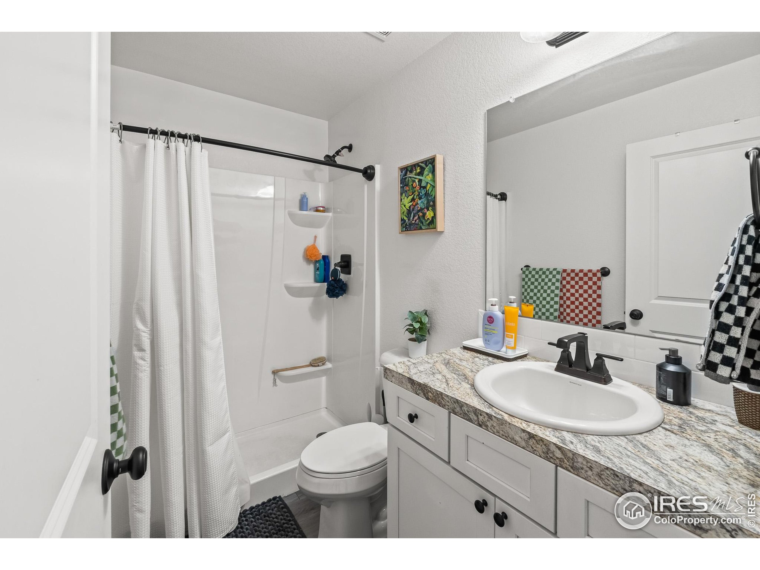 2771 Red Wheat Trail Berthoud, CO 80513 - Photo 32 of 46 a bathroom with a granite countertop sink toilet and shower