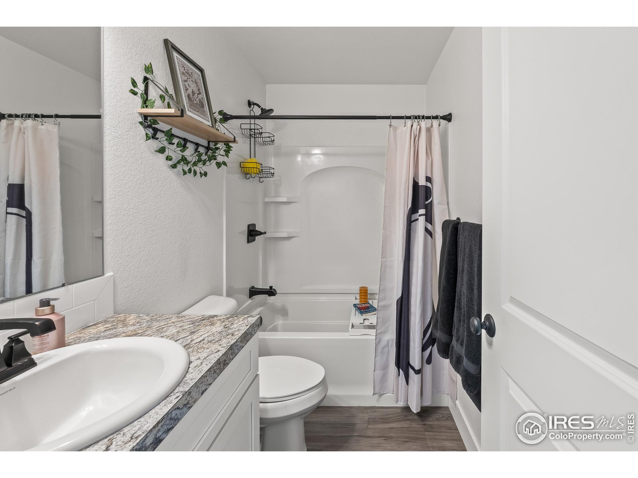 2771 Red Wheat Trail Berthoud, CO 80513 - Photo 37 of 46 a bathroom with a granite countertop sink toilet and shower