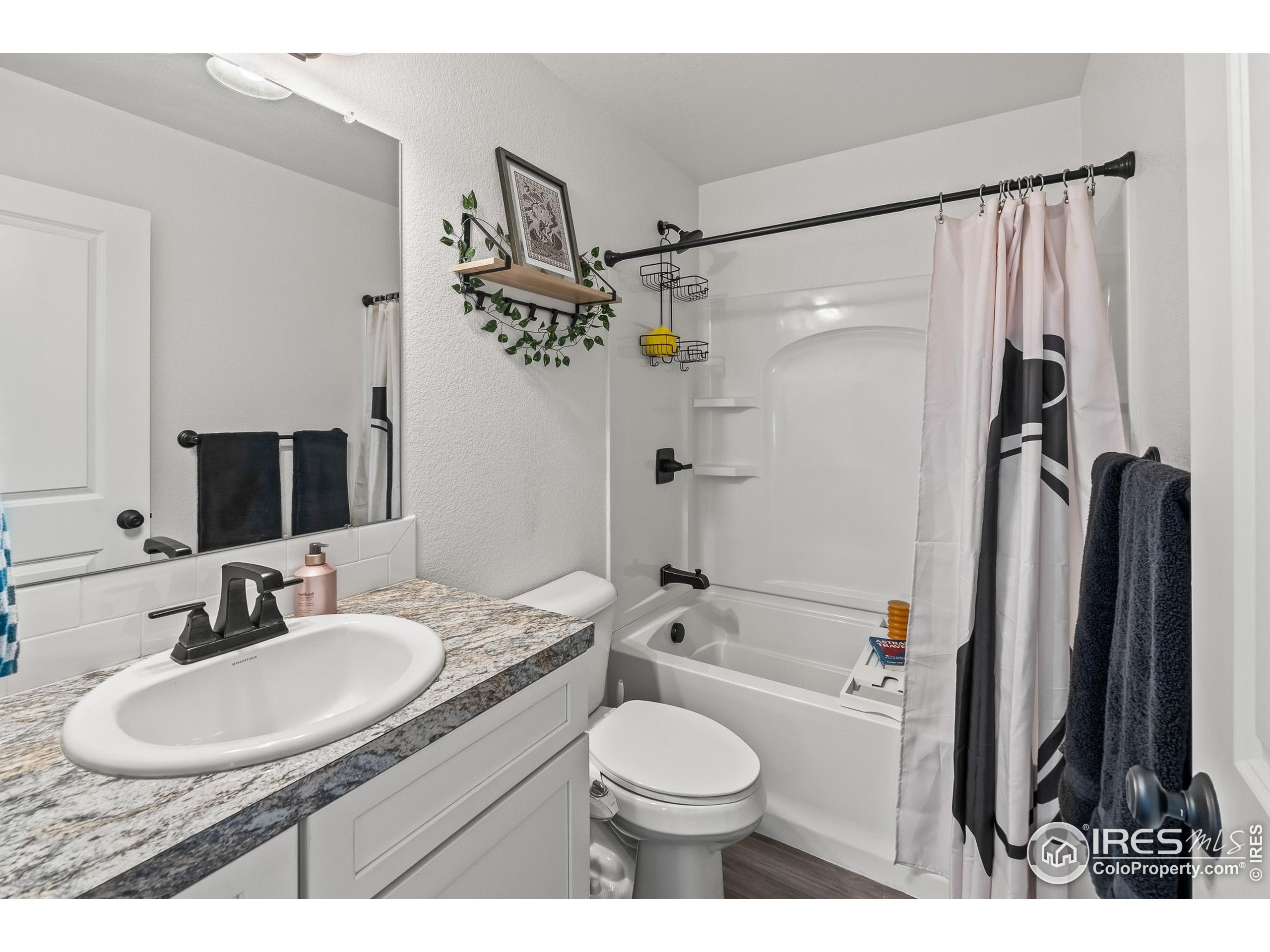 2771 Red Wheat Trail Berthoud, CO 80513 - Photo 38 of 46 a bathroom with a granite countertop sink toilet and shower