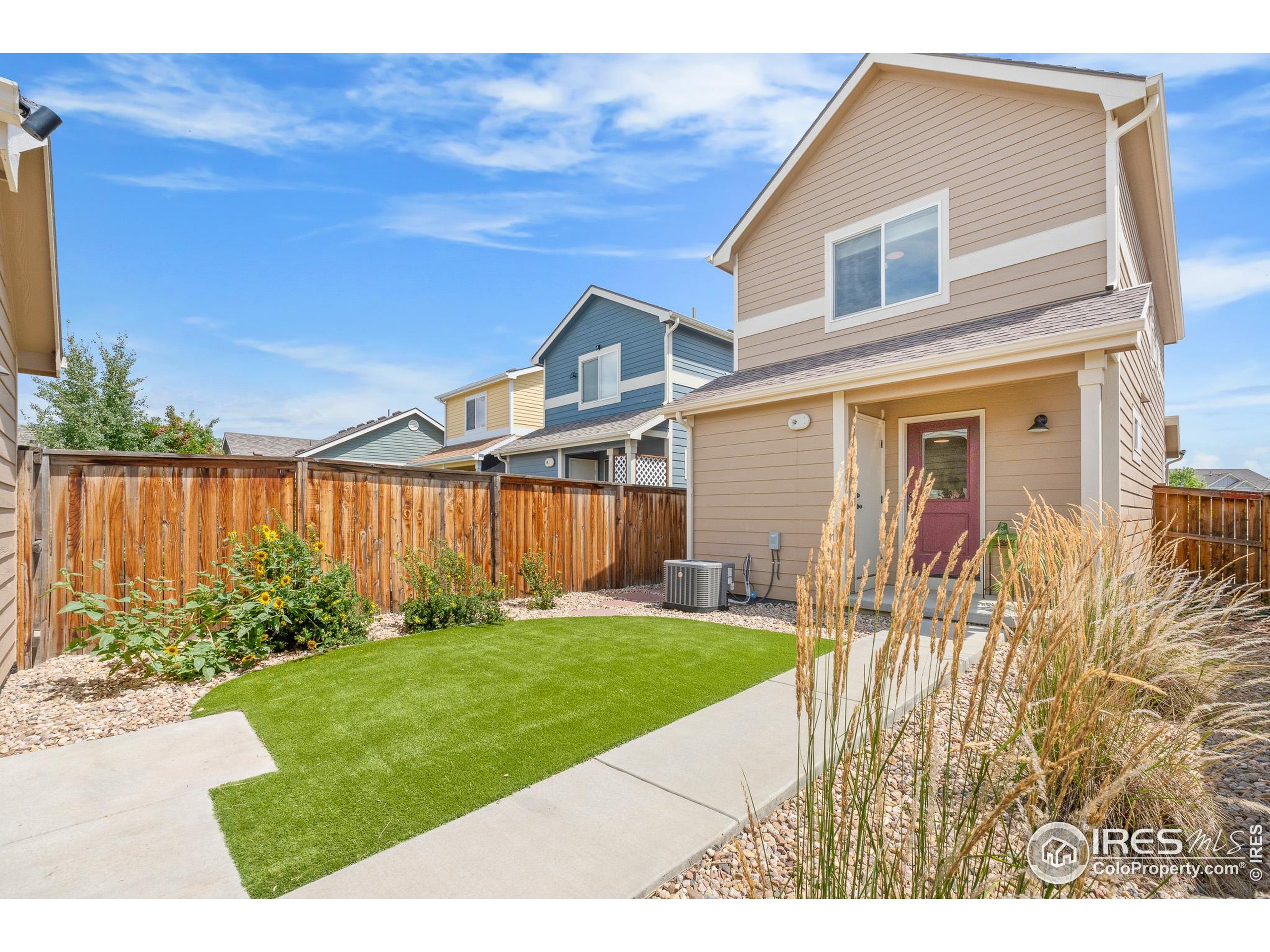 2771 Red Wheat Trail Berthoud, CO 80513 - Photo 45 of 46 a front view of a house with garden