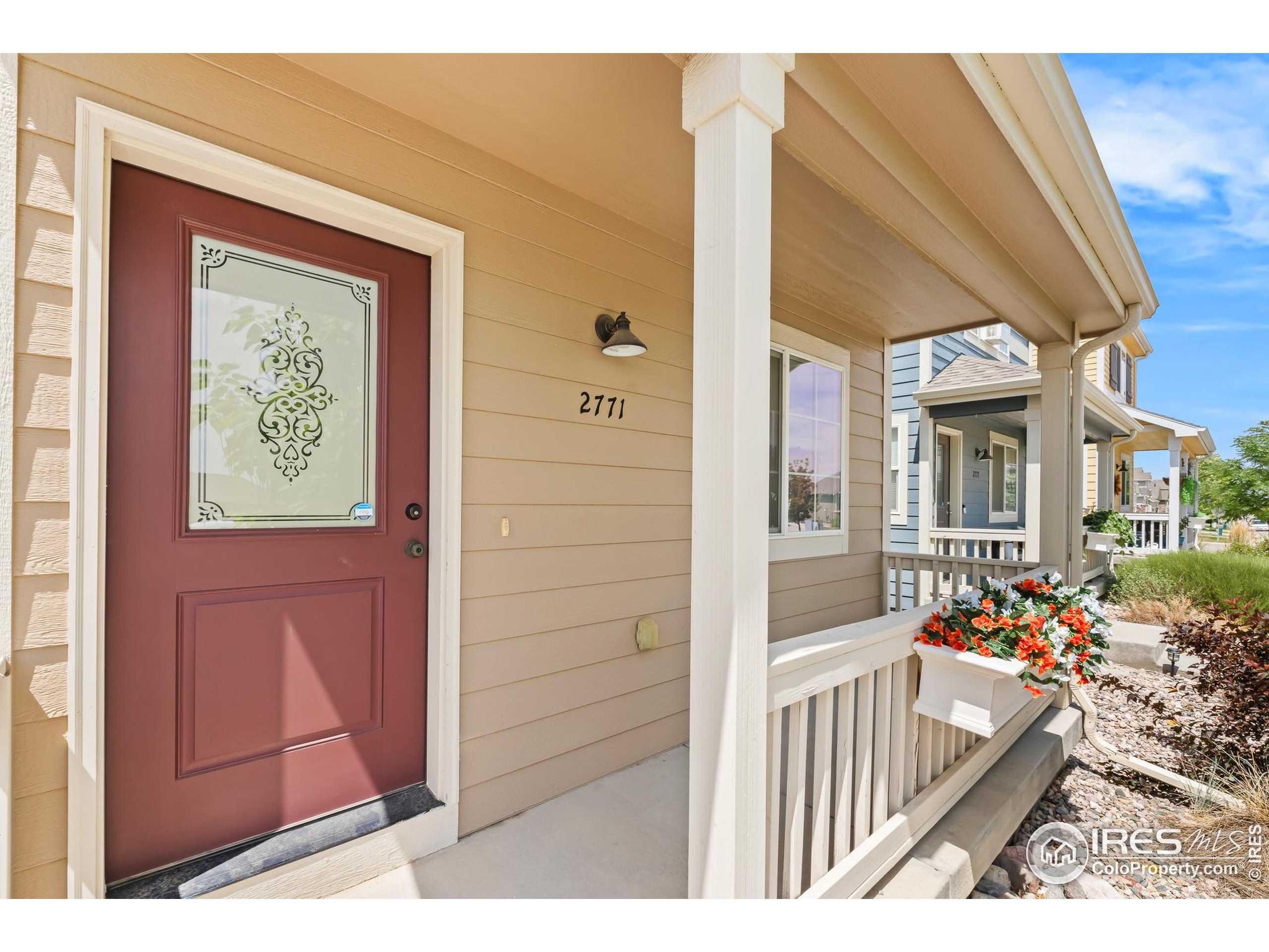 2771 Red Wheat Trail Berthoud, CO 80513 - Photo 6 of 46 a front view of a house with a porch