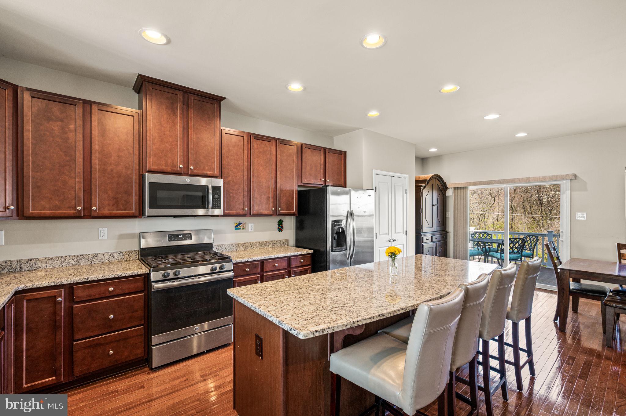 603 Columbus Drive Spring City, PA 19475 - Photo 13 of 35 a kitchen with stainless steel appliances granite countertop a kitchen island hardwood floor sink stove dining table and chairs