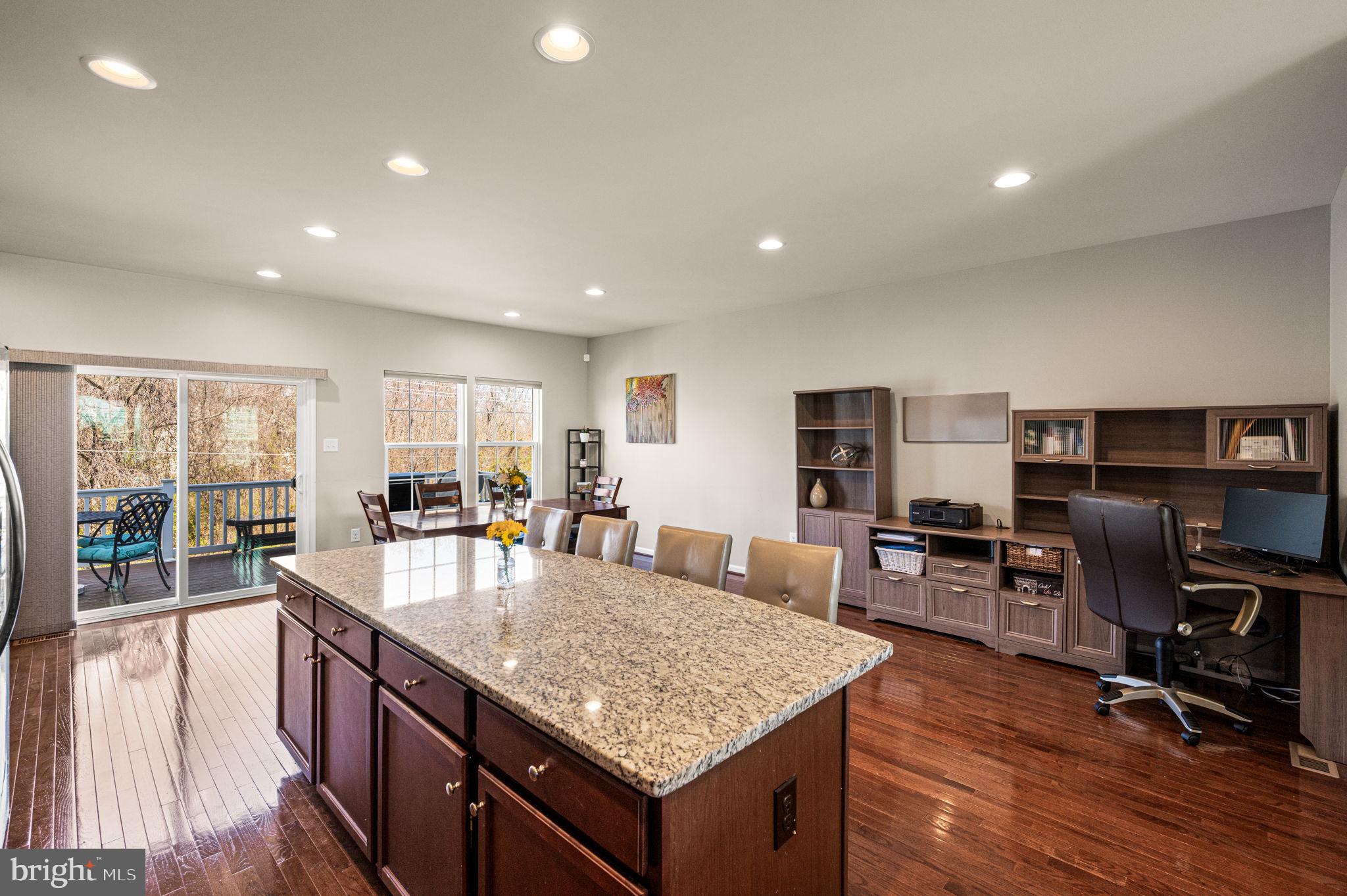 603 Columbus Drive Spring City, PA 19475 - Photo 14 of 35 a kitchen with granite countertop kitchen island stainless steel appliances a table and chairs in it