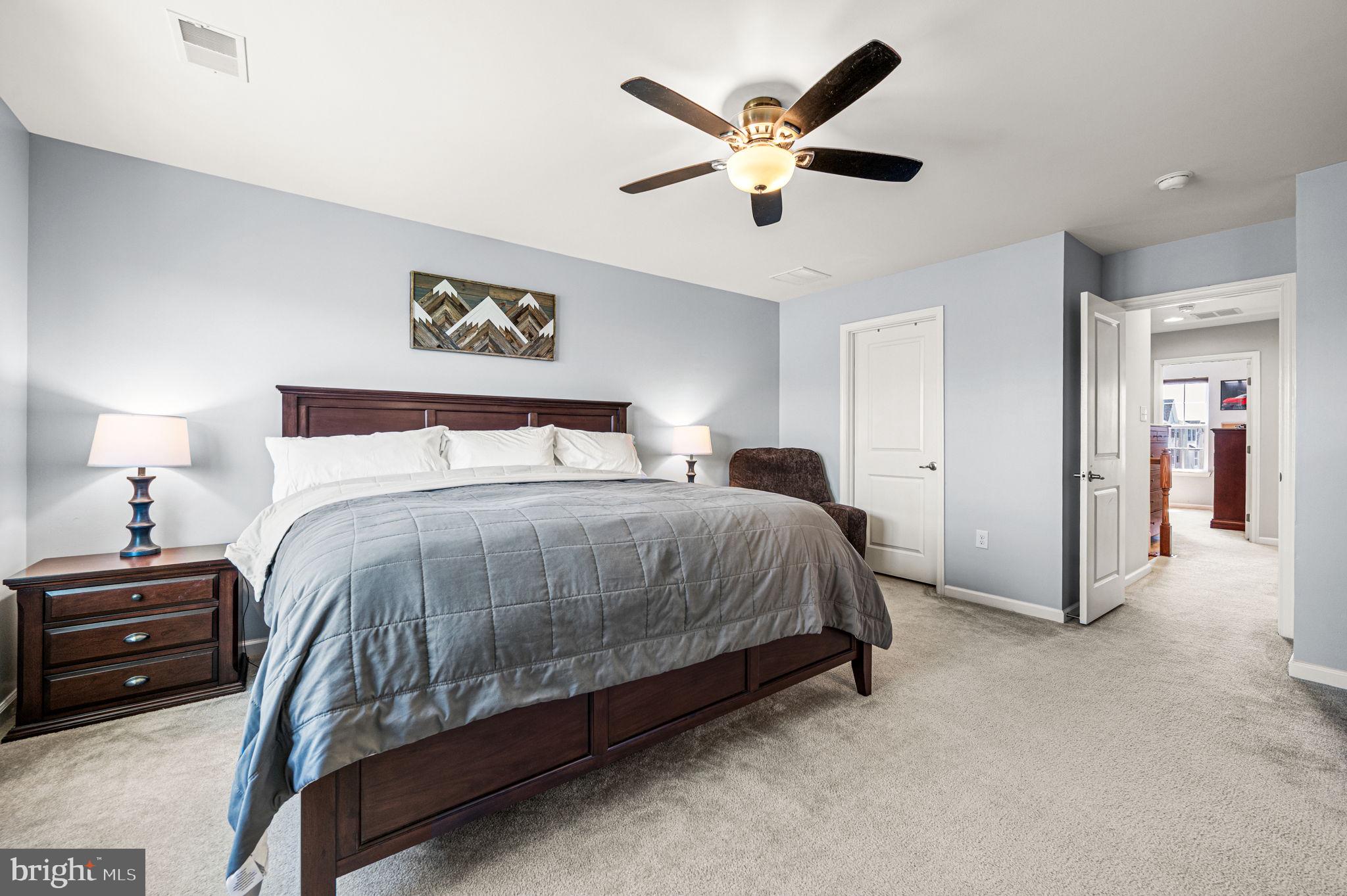 603 Columbus Drive Spring City, PA 19475 - Photo 21 of 35 a bedroom with a large bed and a chandelier