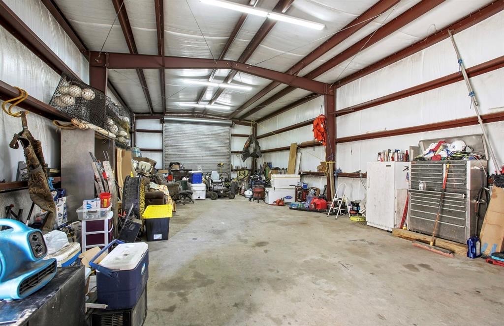 15602 Fir Road Santa Fe, TX 77517 - Photo 35 of 42 Interior photo of shop shows expansive workspace, lighting and insulation.