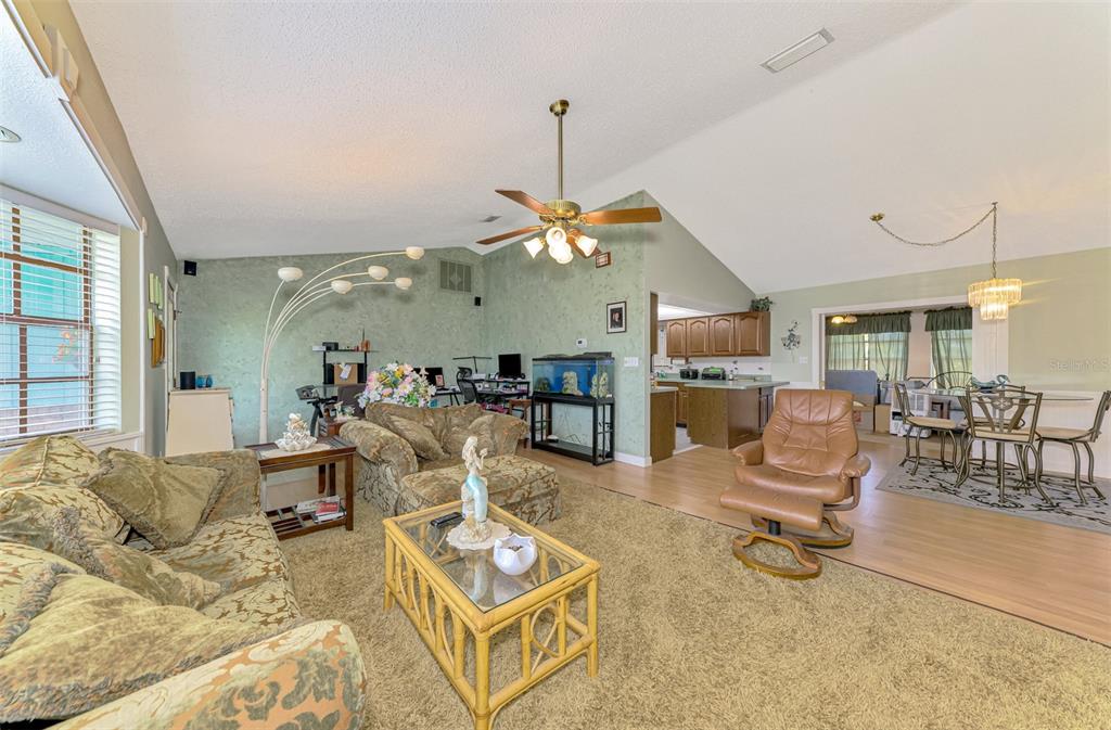 1137 Ponderosa Road Venice, FL 34293 - Photo 9 of 48 a living room with furniture a table and chairs