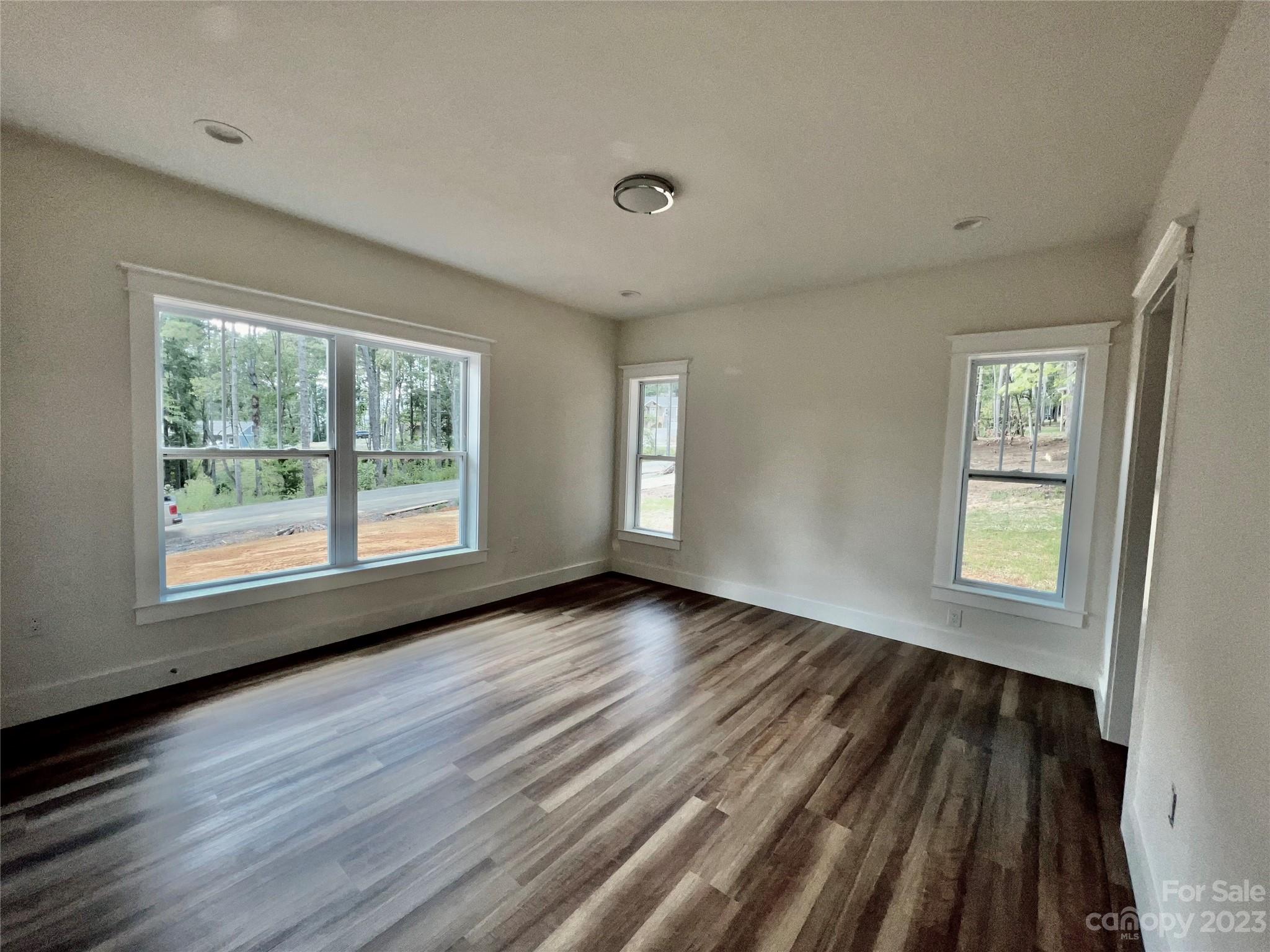 170 Cascade Rdg Road Fairview, NC 28730 - Photo 11 of 23 a view of an empty room with wooden floor and a window